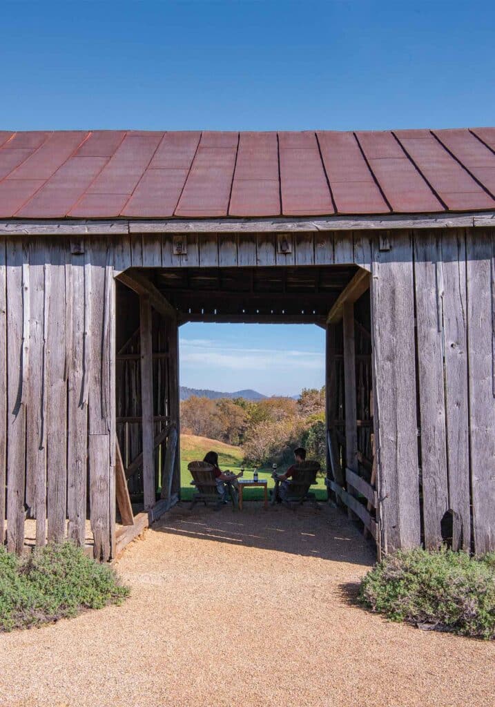 early mt. vineyards couple in barn toasting during fall season