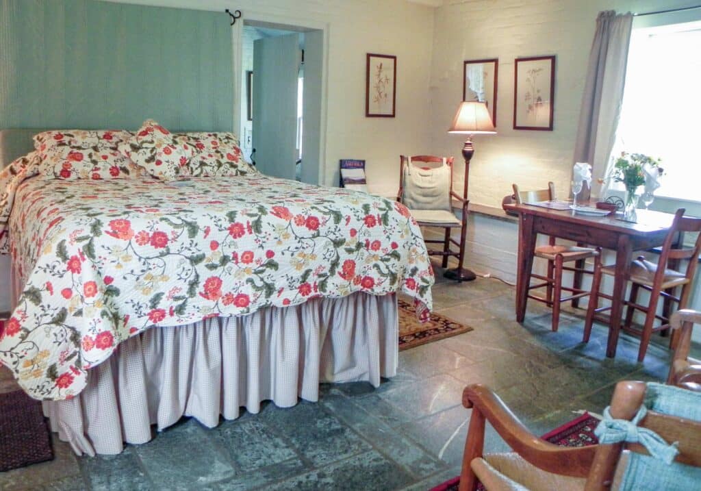 A room with floral linens at the beautiful 1804 Inn at the Virginia Winery, Barboursville Vineyards.