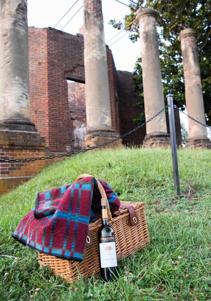 Vermentino wine, a picnic hamper and a picnic blanket ready for a wine picnic near Barboursville Ruins in Virginia Wine Country.