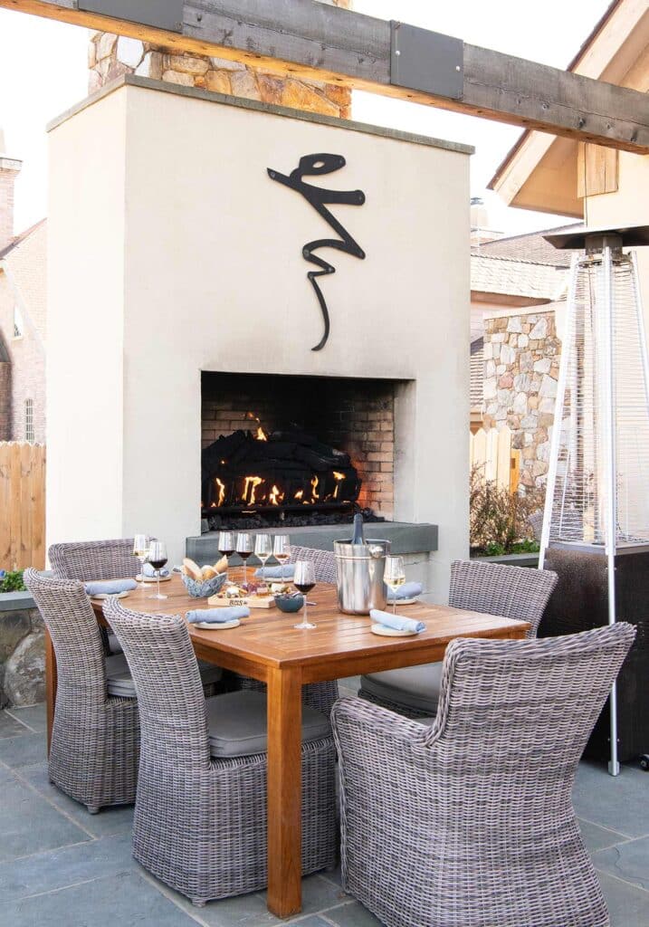 Wine tasting and charcuterie at the table near the outdoor fireplace on the patio at Early Mountains Vineyard.