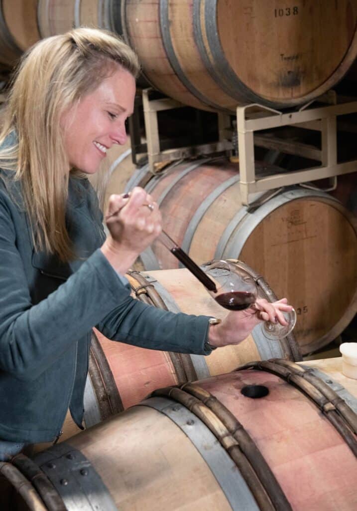 Emily Hodson, winemaker, tapping wine barrel at Veritas Vineyards. Monticello Wine Trail near Charlottesville.