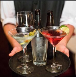 Close-up photo of a server holding a tray of drinks at Aberdeen Barn