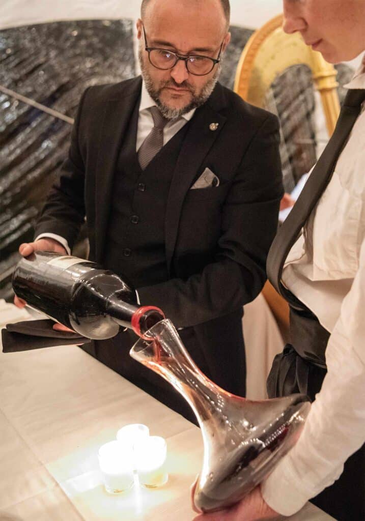 Sommelier Alessandro Medici of Palladio Restaurant decanting red wine at Barboursville Vineyards.