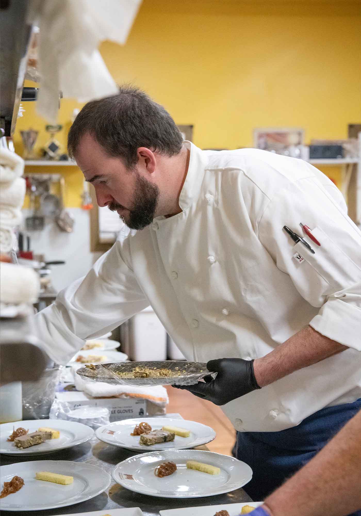 Chef Michael Clough preparing plates at Barboursville Vineyards Palladio Restaurant.