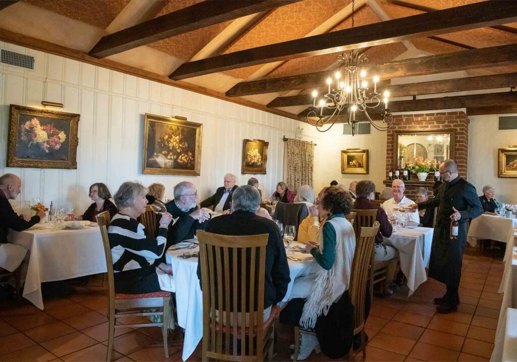 Sommelier Alessandro Medici of Palladio restaurant and Barboursville Vineyards pouring wine for guests at Tuscan Feast created with Castello d'Albola.