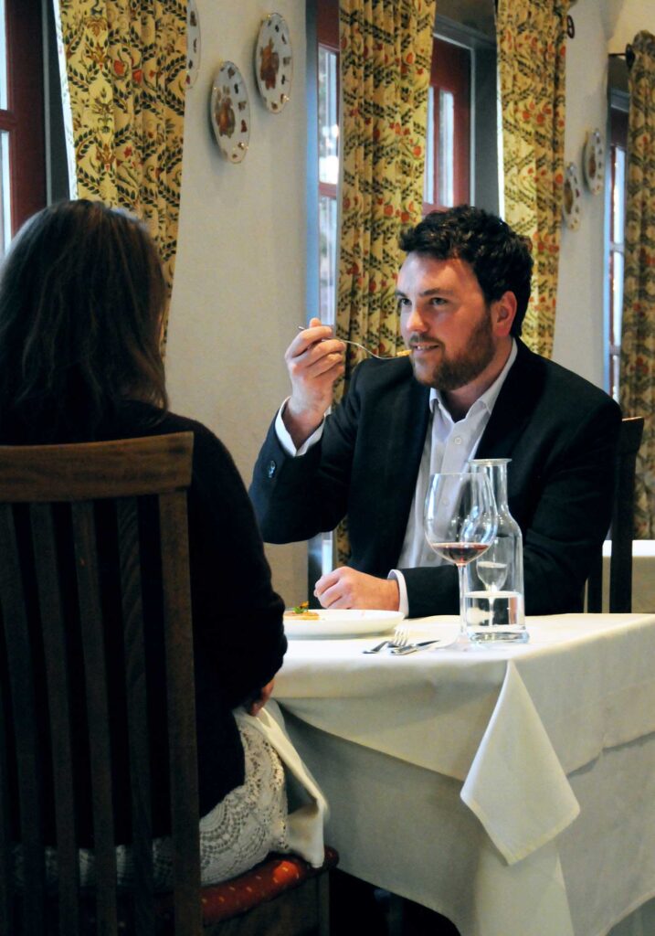 Young couple enjoying romantic wine-paired dinner at Barboursville Vineyards Palladio Restaurant.