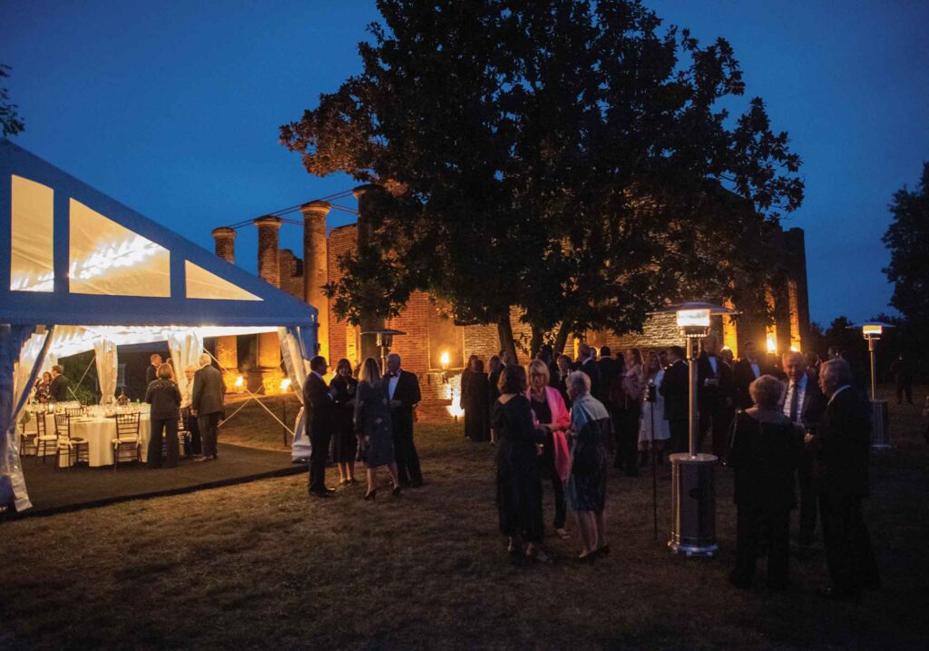 The outdoor tented Tuscan Dinner at Barboursville Vineyards Palladio Restaurant with guests in formal dress.