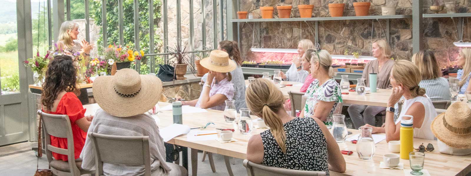 Flower arranging workshop for a group in greenhouse at Pippin Hill Farm & Vineyards by Virginia Wine & Country Life.