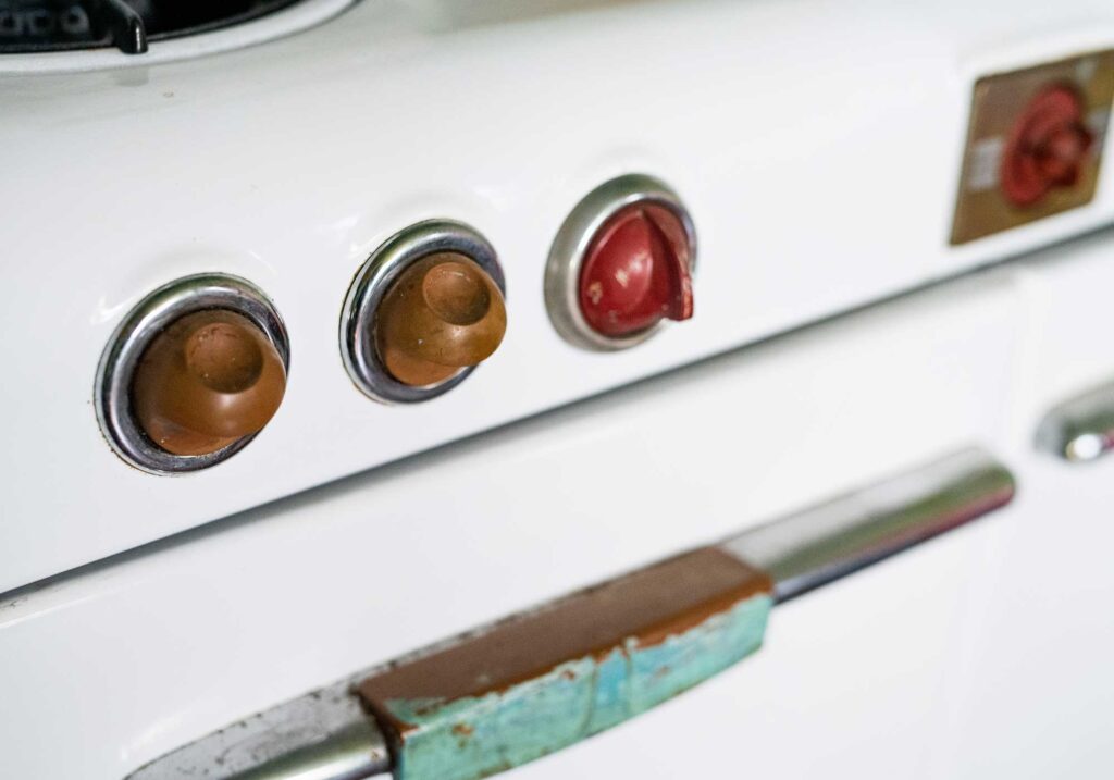 Vintage stove with green and blue accents, red dials in Poet Anne Spencer's kitchen-Anne Spencer Home & Garden Museum.