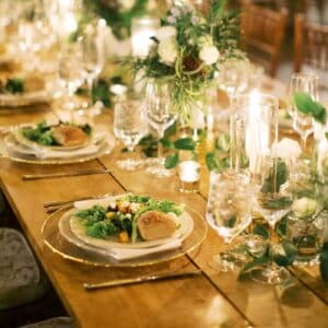 A beautiful food and wine pairing at The Local with fresh flowers on a farm table.