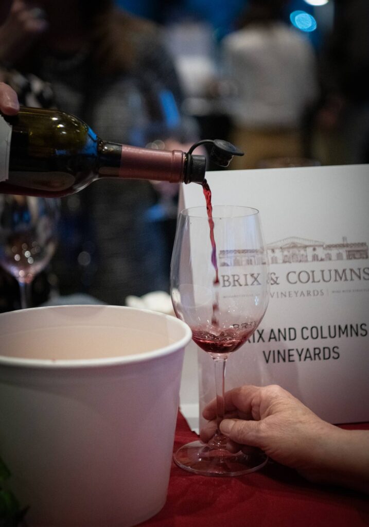 Photo of one of Brie & Columns' red wine being poured into a glass